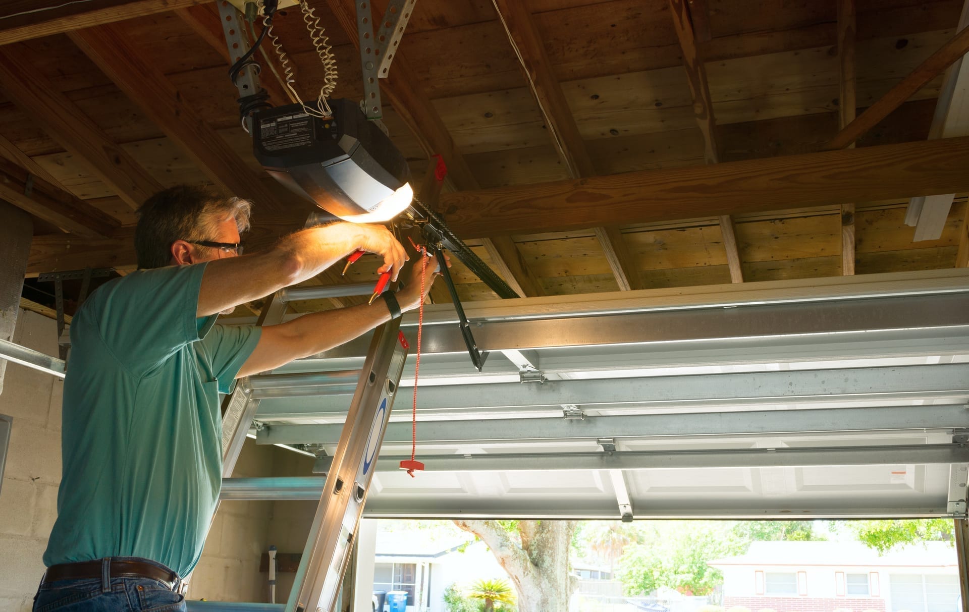 Garage door technician with tablet creating quote at residential or commercial site